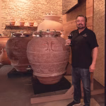 Winemaker standing at an Amphora